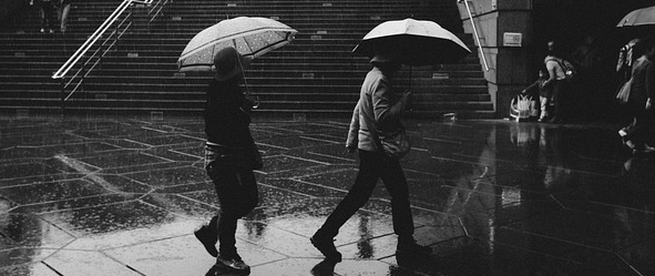 walking in the rain with umbrellas